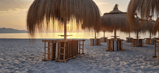 The fine sandy beach of Cala Millor shines in the warm glow of the rising sun